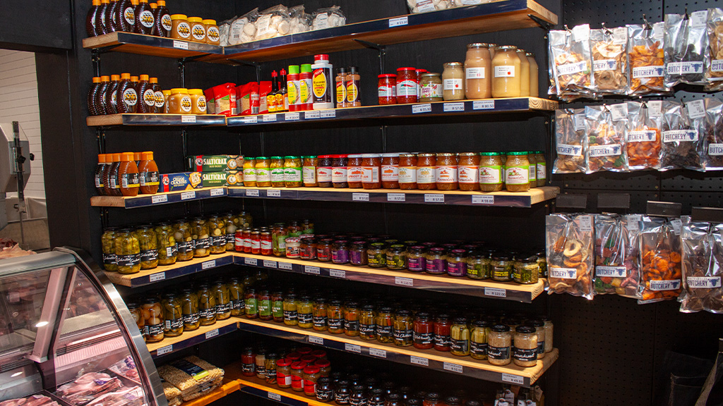 Shelves of honey, jams, pickles and dried fruit